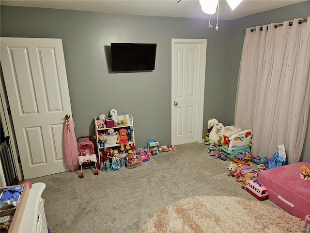 recreation room with carpet flooring and a ceiling fan