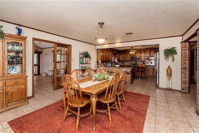 59345 Twin Pines Rd, Bogalusa, LA 70427 - dining area featuring light tile patterned flooring, ceiling fan, baseboards, and crown molding