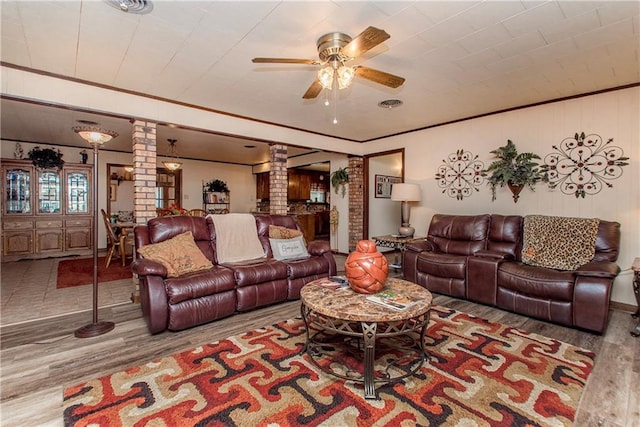 59345 Twin Pines Rd, Bogalusa, LA 70427 - living room with a ceiling fan, wood finished floors, crown molding, and ornate columns