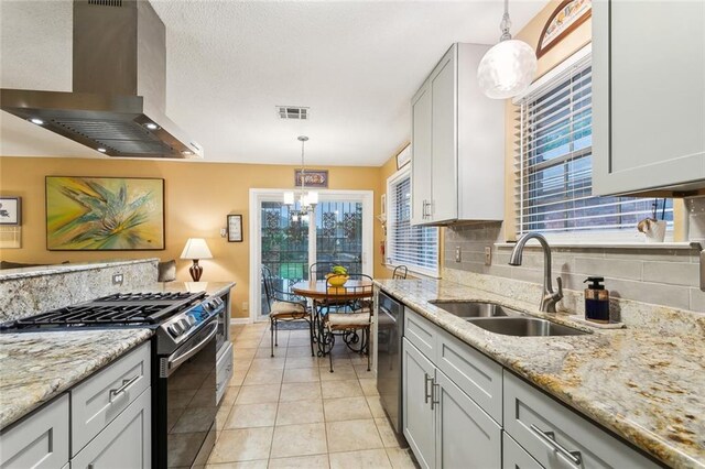 3704 Clearview Pkwy, Metairie, LA 70006 - kitchen with gas range oven, decorative backsplash, a sink, visible vents, and wall chimney exhaust hood