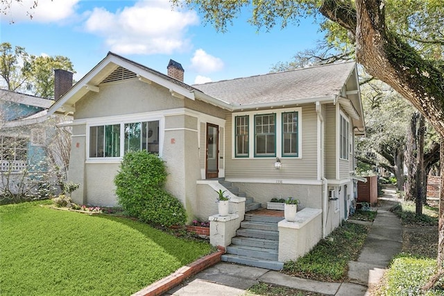 1338 Fern St, New Orleans, LA 70118 - bungalow featuring a chimney, a front lawn, and stucco siding