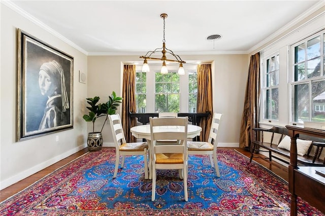 1338 Fern St, New Orleans, LA 70118 - dining space with ornamental molding, baseboards, and wood finished floors