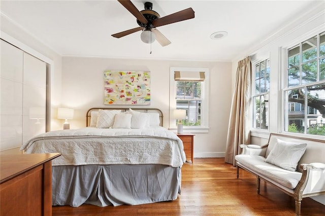 1338 Fern St, New Orleans, LA 70118 - bedroom with multiple windows, light wood-style floors, baseboards, and ceiling fan
