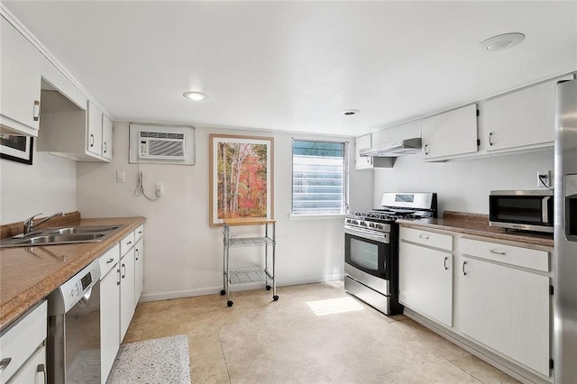 1338 Fern St, New Orleans, LA 70118 - kitchen featuring stainless steel appliances, a sink, under cabinet range hood, a wall unit AC, and baseboards