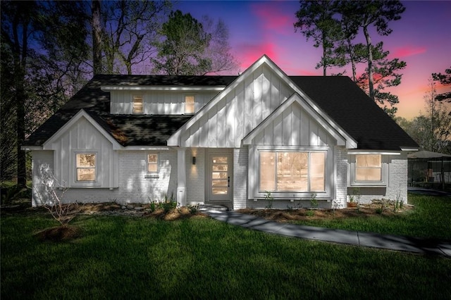 156 Belle Terre Blvd, Covington, LA 70433 - view of front facade with brick siding, a yard, a shingled roof, and board and batten siding