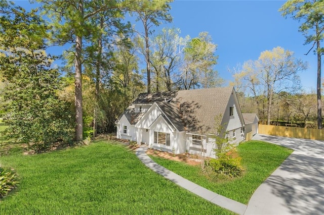 156 Belle Terre Blvd, Covington, LA 70433 - view of front of property with concrete driveway, a shingled roof, a front yard, and stucco siding