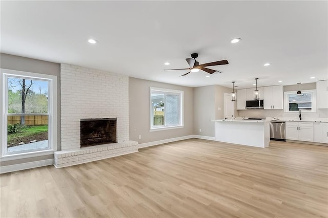 156 Belle Terre Blvd, Covington, LA 70433 - unfurnished living room featuring light wood finished floors, baseboards, recessed lighting, ceiling fan, and a fireplace