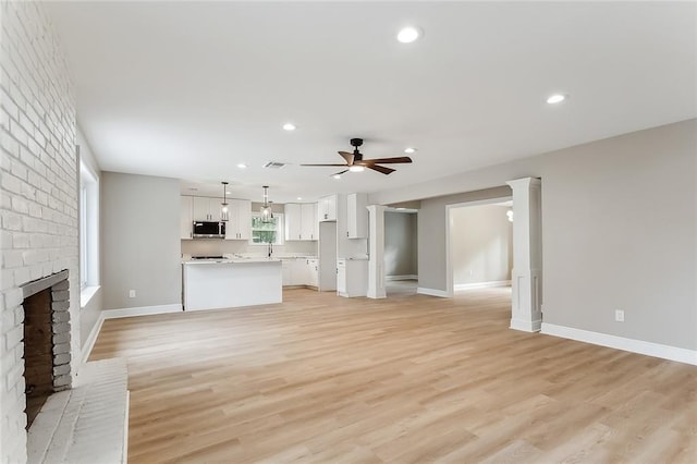 156 Belle Terre Blvd, Covington, LA 70433 - unfurnished living room with a ceiling fan, a fireplace, light wood finished floors, baseboards, and recessed lighting