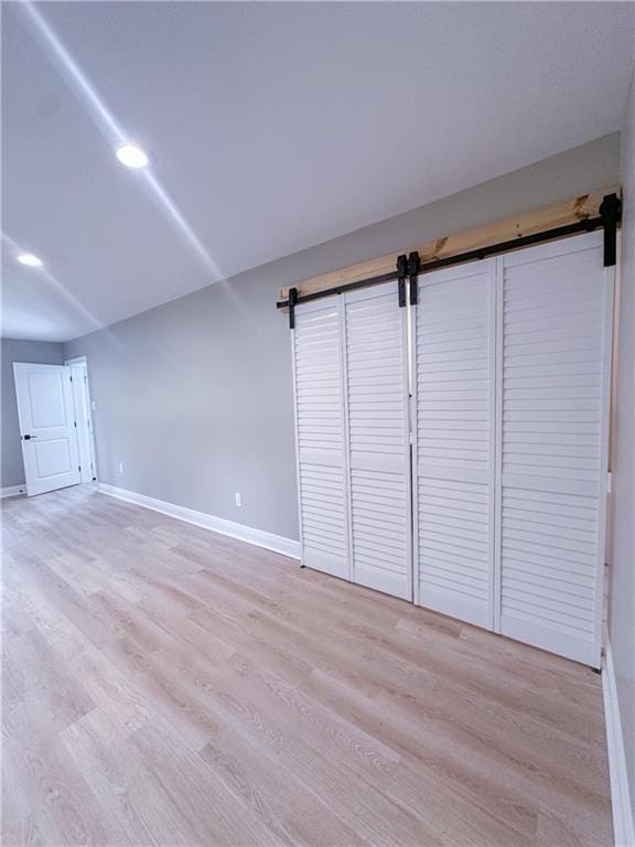 156 Belle Terre Blvd, Covington, LA 70433 - spare room with a barn door and light wood-type flooring