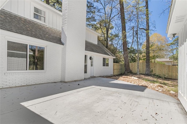 156 Belle Terre Blvd, Covington, LA 70433 - back of house with fence, brick siding, board and batten siding, a chimney, and a patio