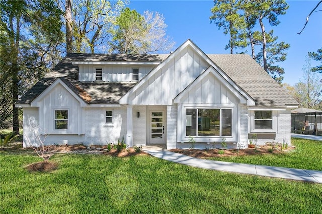 156 Belle Terre Blvd, Covington, LA 70433 - view of front facade featuring brick siding, board and batten siding, a front lawn, and roof with shingles