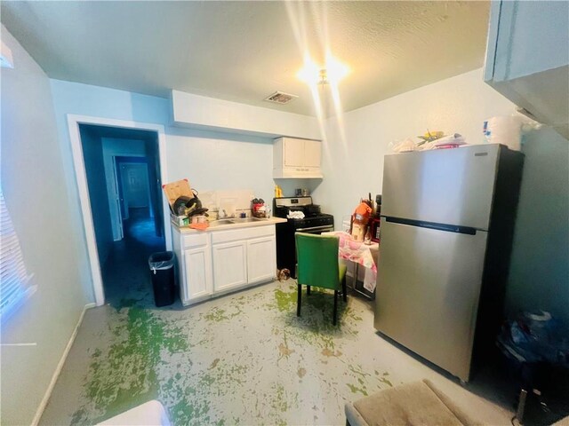 412729 Hollygrove St, New Orleans, LA 70118 - kitchen with white cabinets, visible vents, concrete floors, appliances with stainless steel finishes, and a sink