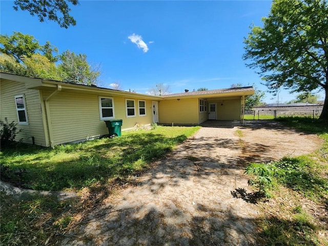 167 Celia Dr, Luling, LA 70070 - back of house featuring driveway, a carport, and fence