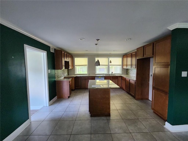 167 Celia Dr, Luling, LA 70070 - kitchen featuring light tile patterned floors, a sink, ornamental molding, and a center island