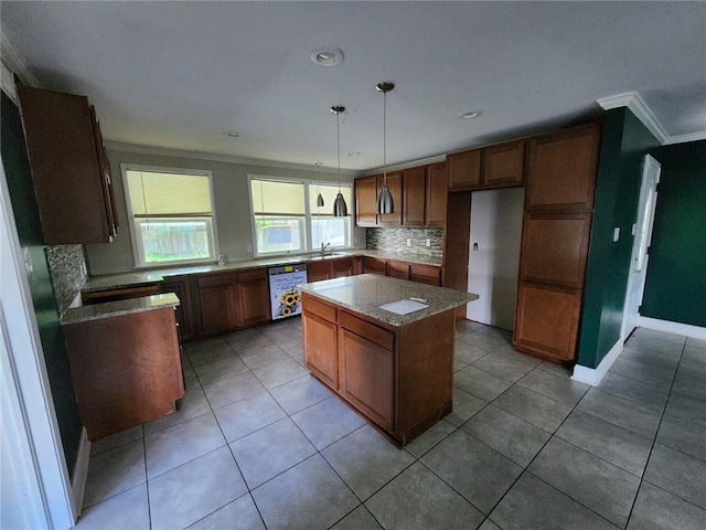 167 Celia Dr, Luling, LA 70070 - kitchen featuring a sink, a kitchen island, dishwasher, decorative backsplash, and ornamental molding