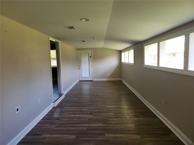 167 Celia Dr, Luling, LA 70070 - unfurnished room with dark wood-style floors, baseboards, lofted ceiling, and visible vents