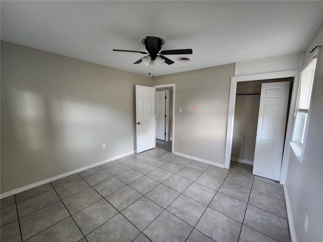167 Celia Dr, Luling, LA 70070 - unfurnished bedroom featuring a closet, visible vents, baseboards, ceiling fan, and light tile patterned floors