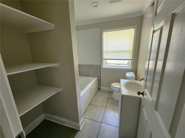 167 Celia Dr, Luling, LA 70070 - bathroom featuring tile patterned floors, toilet, vanity, a garden tub, and baseboards