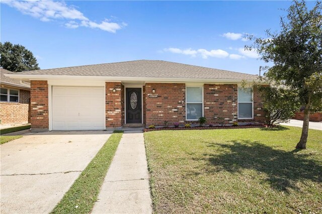 4232 Connecticut Ave, Kenner, LA 70065 - single story home with concrete driveway, a garage, a front lawn, and brick siding
