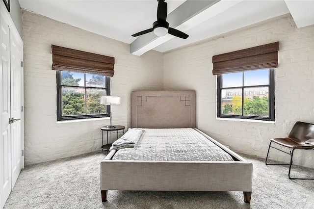 bedroom featuring carpet floors, ceiling fan, and multiple windows