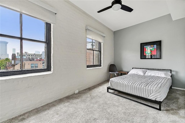 carpeted bedroom with ceiling fan and a city view