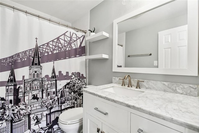 full bathroom with toilet and vanity