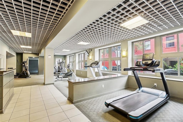 exercise room with carpet floors and baseboards