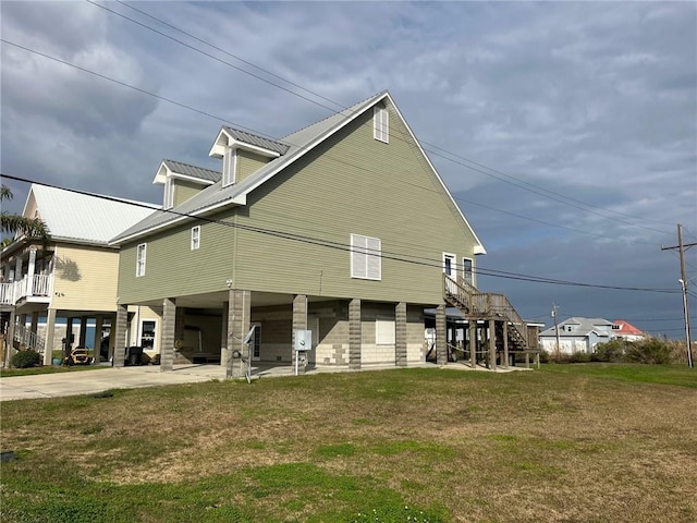 100 Deer Range Ln, Port Sulphur, LA 70083 - view of property exterior featuring stairway, a carport, a yard, driveway, and metal roof
