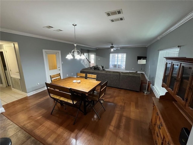 100 Deer Range Ln, Port Sulphur, LA 70083 - dining room featuring crown molding, visible vents, wood finished floors, and ceiling fan with notable chandelier