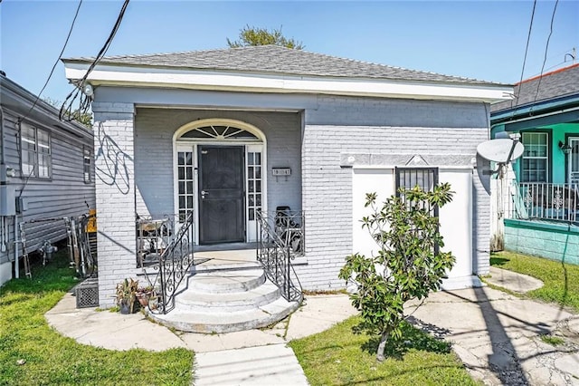 1983 Law St, New Orleans, LA 70119 - doorway to property with brick siding and a porch