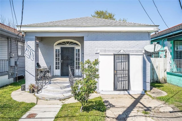 1983 Law St, New Orleans, LA 70119 - doorway to property with covered porch and brick siding