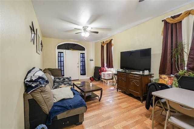 1983 Law St, New Orleans, LA 70119 - living area featuring a ceiling fan, arched walkways, and light wood-style flooring