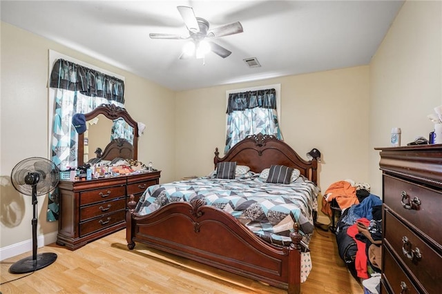 1983 Law St, New Orleans, LA 70119 - bedroom featuring baseboards, visible vents, light wood-style floors, and a ceiling fan