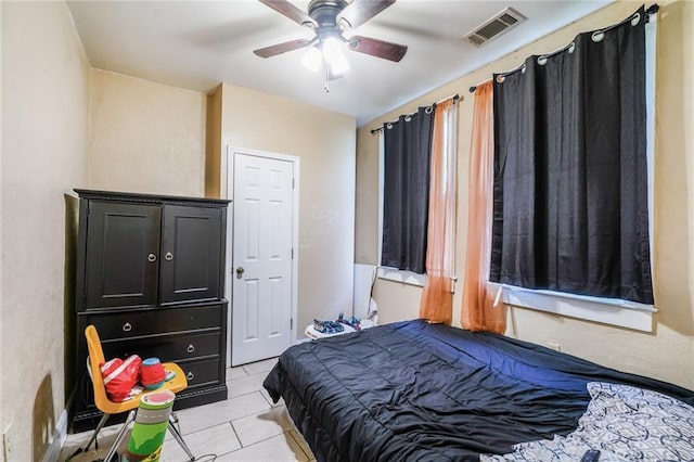 1983 Law St, New Orleans, LA 70119 - bedroom with visible vents, ceiling fan, and light tile patterned floors