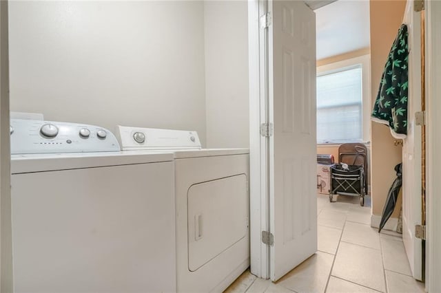 1983 Law St, New Orleans, LA 70119 - washroom with light tile patterned flooring, laundry area, and separate washer and dryer