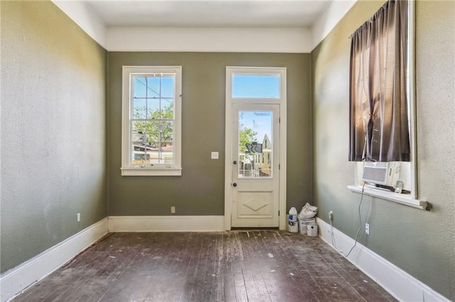 133234 Port St, New Orleans, LA 70117 - entryway with baseboards, cooling unit, and wood-type flooring