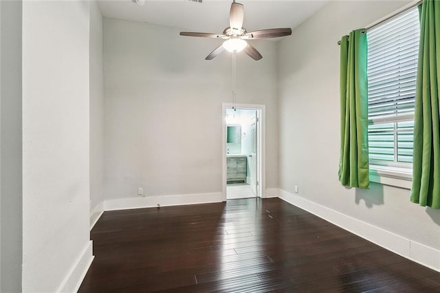 2725 Philip St, New Orleans, LA 70113 - spare room featuring dark wood-type flooring, baseboards, and ceiling fan