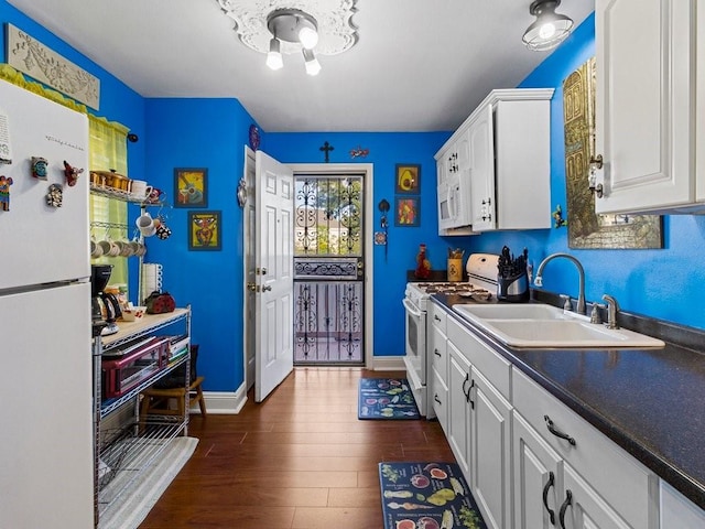 18 Curtis Dr, New Orleans, LA 70126 - kitchen featuring dark wood-style flooring, white appliances, dark countertops, white cabinetry, and a sink