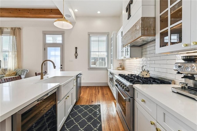 125 Elmira Ave, New Orleans, LA 70114 - kitchen with appliances with stainless steel finishes, custom exhaust hood, beverage cooler, tasteful backsplash, and light countertops