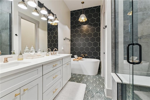 125 Elmira Ave, New Orleans, LA 70114 - full bathroom featuring double vanity, a soaking tub, a shower stall, and tile walls