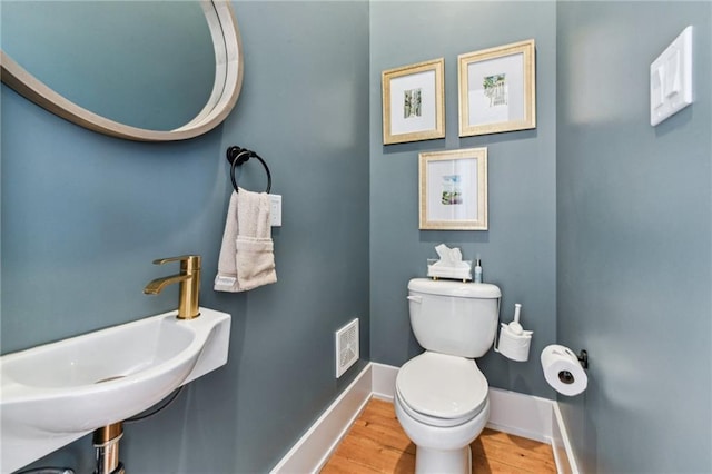 125 Elmira Ave, New Orleans, LA 70114 - half bathroom with toilet and wood finished floors