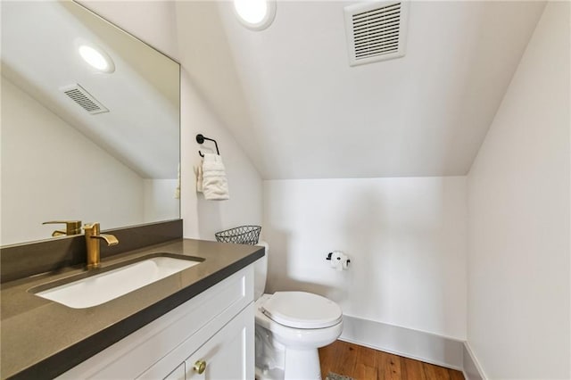 125 Elmira Ave, New Orleans, LA 70114 - half bath featuring vaulted ceiling, vanity, and wood finished floors