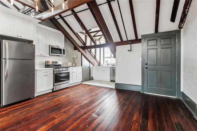 516 Governor Nicholls St Unit 401, New Orleans, LA 70116 - kitchen featuring white cabinets, a sink, stainless steel appliances, vaulted ceiling with beams, and dark wood-type flooring