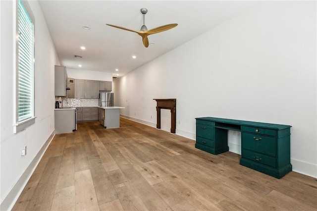 4235 Tulane Ave, New Orleans, LA 70119 - unfurnished living room with light wood-style floors, ceiling fan, baseboards, recessed lighting, and a desk