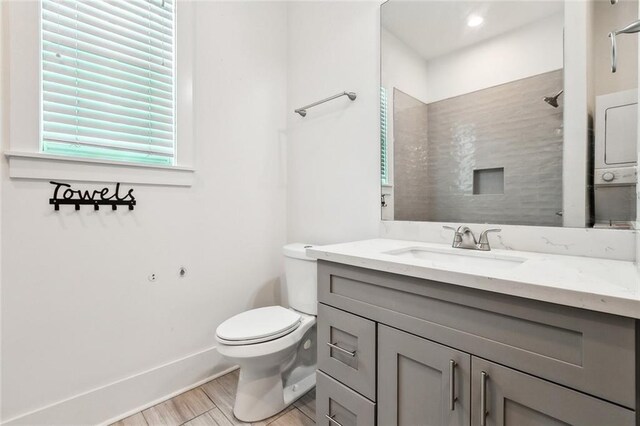 4235 Tulane Ave, New Orleans, LA 70119 - bathroom featuring vanity, toilet, baseboards, wood finished floors, and a shower