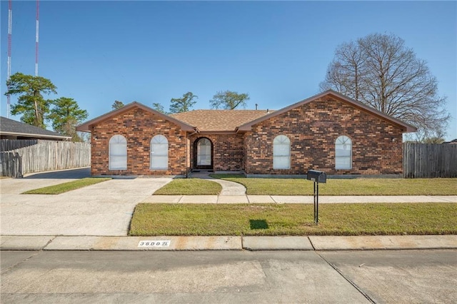 3800 Decomine Dr, Chalmette, LA 70043 - single story home featuring brick siding, a front yard, driveway, and fence