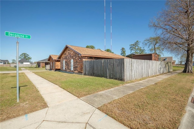 3800 Decomine Dr, Chalmette, LA 70043 - view of side of home with brick siding, fence, and a lawn