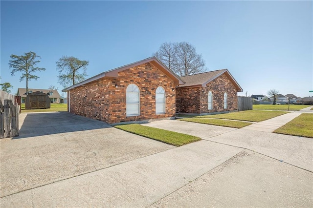 3800 Decomine Dr, Chalmette, LA 70043 - single story home with a front yard, fence, brick siding, and concrete driveway