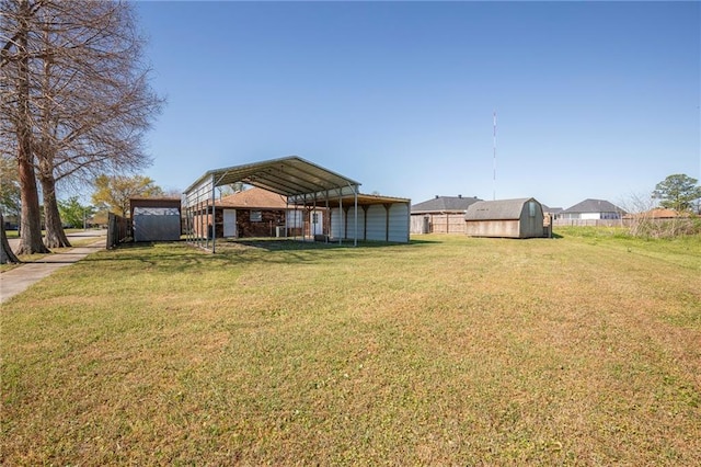 3800 Decomine Dr, Chalmette, LA 70043 - view of yard with an outdoor structure, fence, a carport, and a shed