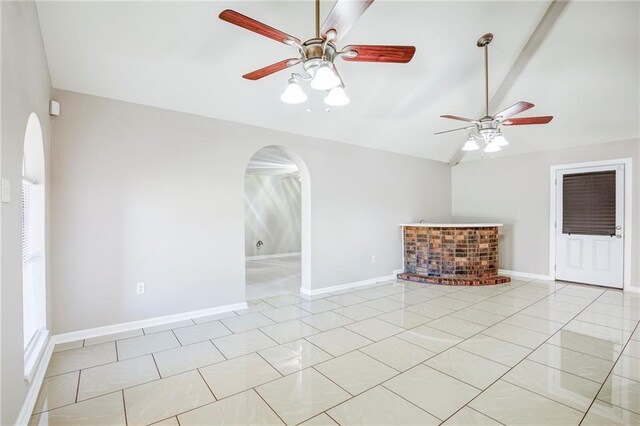 3800 Decomine Dr, Chalmette, LA 70043 - unfurnished room featuring light tile patterned flooring, baseboards, ceiling fan, arched walkways, and vaulted ceiling with beams